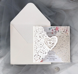 Laser-cut floral wedding invitation set with cream envelope and elegant inner card