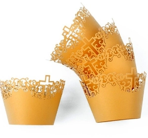 Detailed laser-cut hollow cross and lace patterns on gold cupcake wrappers for weddings
