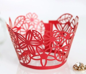 Laser-cut red floral paper cupcake wrappers with intricate flower and leaf patterns