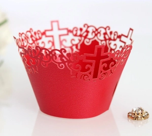 Laser-cut red paper cupcake wrappers with elegant hollow cross design for weddings