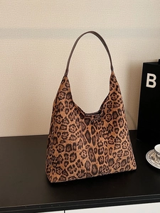 Large leopard print canvas tote bag with brown leather shoulder strap for casual daily use