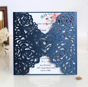 Detailed laser-cut floral pattern on navy blue pearlescent paper wedding invitation