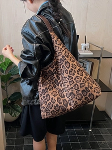 Large capacity leopard print tote bag with brown leather straps shown on shoulder