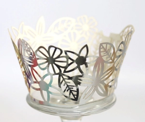 Detailed laser-cut silver flower pattern cupcake wrapper with iridescent metallic finish