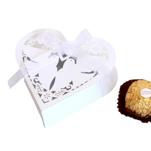 White laser-cut heart favor box with delicate flower patterns and white organza ribbon