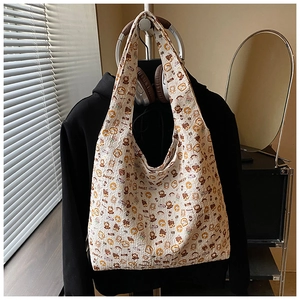 Close-up of quilted fabric texture and colorful cartoon prints on a white tote bag