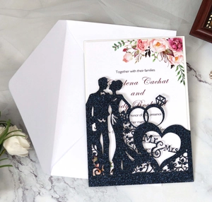 Detail showing navy glitter laser-cut Mr & Mrs wedding invitation with floral inner card