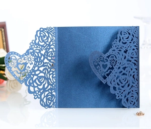 Detailed laser-cut dark blue invitation card with intricate rose and heart patterns