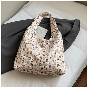 Close-up of white bubble pleated tote bag with sweet brown bear and dessert patterns