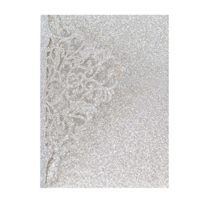 Detail of laser-cut lace pattern on shimmering silver glitter paper for invitation card