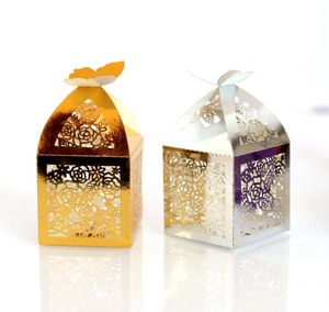 Detail of laser-cut butterfly gift boxes with rose patterns in gold and silver finish