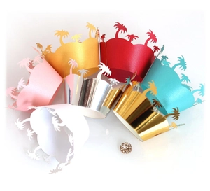 Laser cut tropical palm tree cupcake wrappers in assorted metallic and pearlescent colors