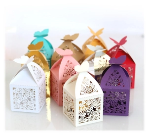 Laser-cut floral favor boxes with butterfly closures in assorted pearlescent colors