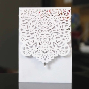 White laser-cut rose floral wedding invitation with elegant hollow patterns and diamond drop