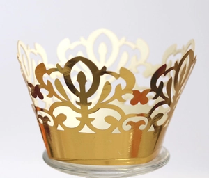 Golden laser-cut cupcake wrappers with intricate crown lace pattern for dessert decoration