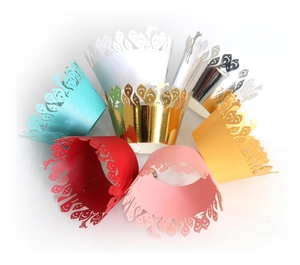 Laser-cut cupcake wrappers with hollow lace patterns in various metallic colors
