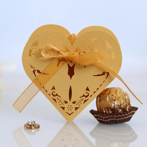 Exquisite golden heart-shaped laser cut wedding favors box with elegant silk ribbon bow