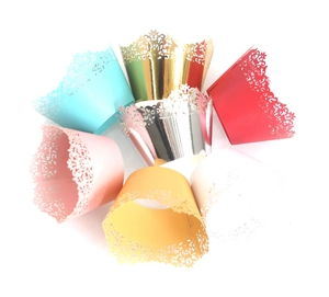 Laser-cut lace cupcake wrappers in various colors for wedding and birthday parties