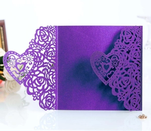 Close-up of laser-cut heart and rose patterns on dark purple pearlescent greeting card