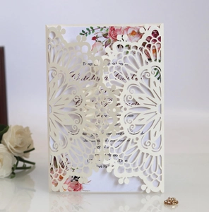 Detail view of laser-cut mandala wedding invitation with floral insert and ivory paper