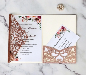 Detail of rose gold laser cut wedding invitation with floral insert and RSVP card