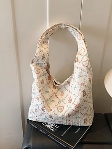 Quilted white tote bag with colorful cartoon prints and spacious interior for daily use