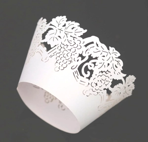 White laser cut cupcake wrapper featuring intricate grape vine leaf patterns for weddings