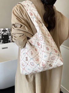 Quilted tote bag with cute animal prints shown on a person wearing a beige coat