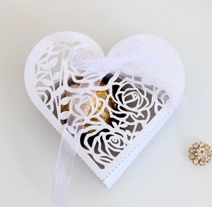 Elegant laser-cut heart candy box with rose pattern and white ribbon for weddings