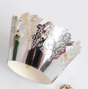 Silver laser-cut cupcake wrappers with intricate grape and leaf lace design for parties