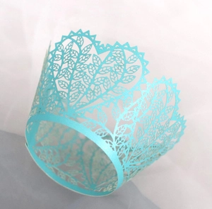Light blue laser-cut cupcake wrappers with hollow leaf pattern and serrated edges