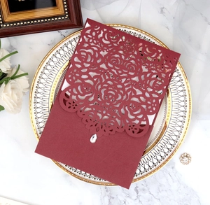 Detailed laser-cut rose hollow wedding invitation card with sparkling diamond embellishment