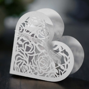 Laser cut heart shaped white wedding favor box with rose patterns and silver ribbon