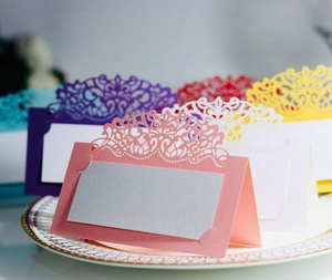 Elegant laser-cut lace wedding place cards in assorted pearlescent colors for table settings