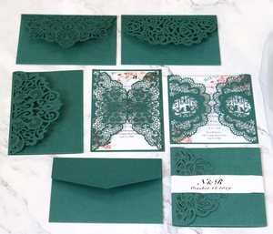 Forest green laser-cut wedding invitation set with floral lace and matching envelopes