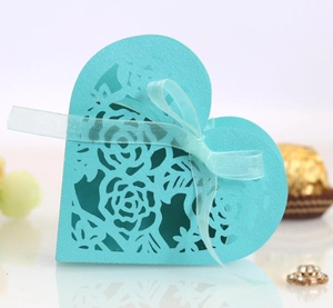 Détail macro de boîte cadeau bleu tiffany en forme de cœur avec motifs de roses découpés