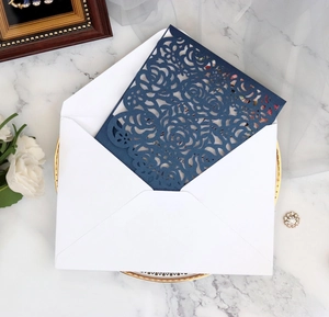 Laser cut navy rose wedding invitation with envelope on elegant marble surface