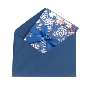 Navy blue laser-cut wedding invitation set with floral inner card and silk ribbon bow