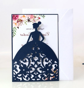 Macro view of laser-cut dark green wedding invitation with elegant floral lace details