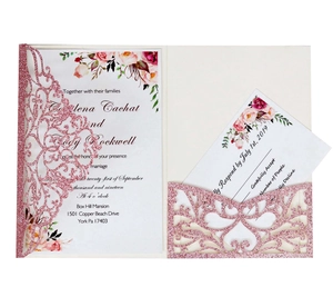 Detail of laser-cut glitter wedding invitation set with floral design and RSVP card