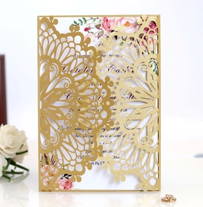 Detailed view of laser-cut gold wedding invitation with floral printed inner card insert