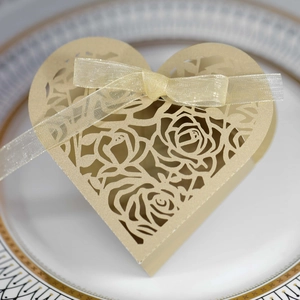 Detailed laser-cut rose patterns on elegant gold heart-shaped wedding favor box