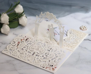 Detailed laser cut wedding invitation card featuring 3D archway and romantic couple silhouette