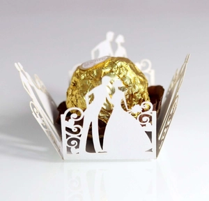 Detailed laser-cut white wedding candy box featuring elegant bride and groom silhouettes
