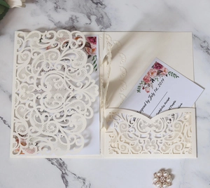 Laser cut wedding invitation set with intricate hollow floral patterns and RSVP cards