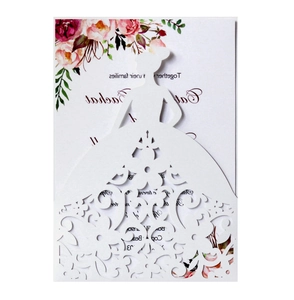 Macro detail of laser-cut bride silhouette wedding card with elegant floral lace patterns