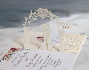 Detail of 3D laser-cut wedding invitation featuring romantic arch and heart silhouettes