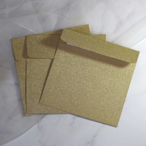 Elegant square gold glitter envelopes for wedding invitations and holiday greeting cards