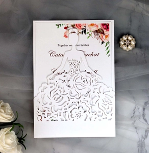 Detail of laser-cut rose floral wedding invitation card with elegant bride silhouette