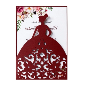 Detail of burgundy laser-cut wedding invitation featuring elegant bride silhouette and floral texture